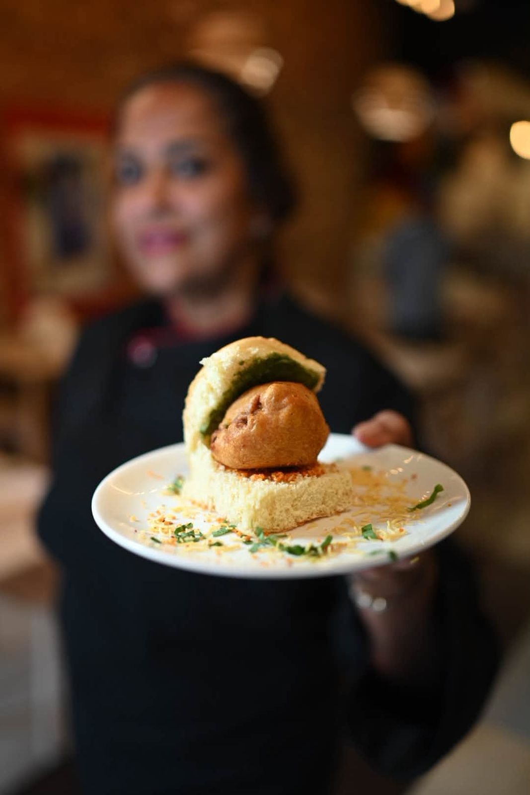 Anita holding up a vada pao slider